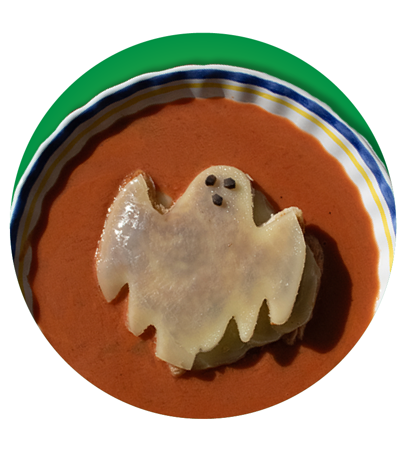 Bowl of tomato soup with ghost shaped grilled cheese